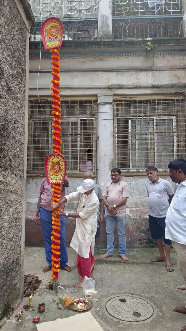 The priest performs the khuti puja in the lane
