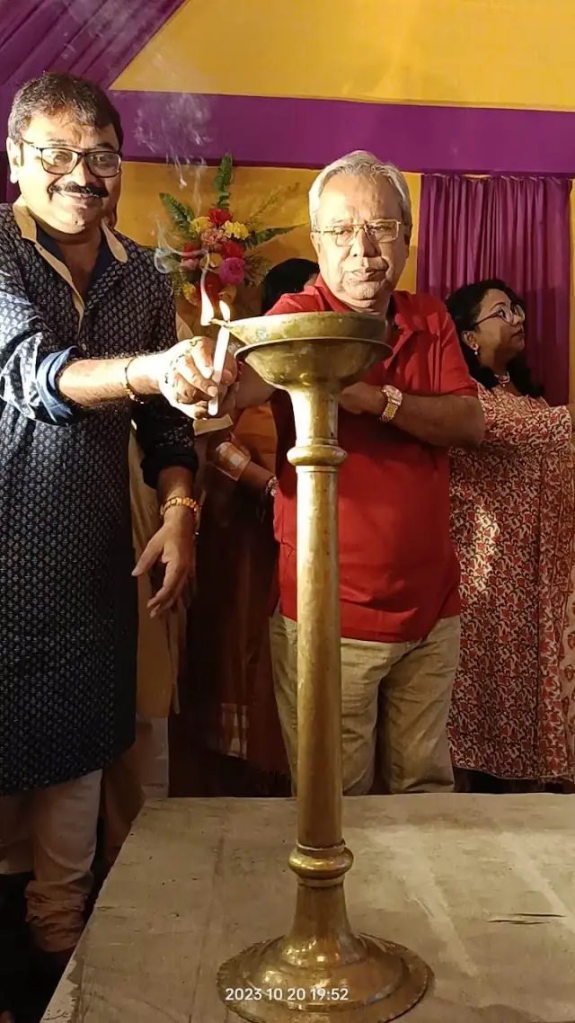Lighting the lamp to inaugurate the puja